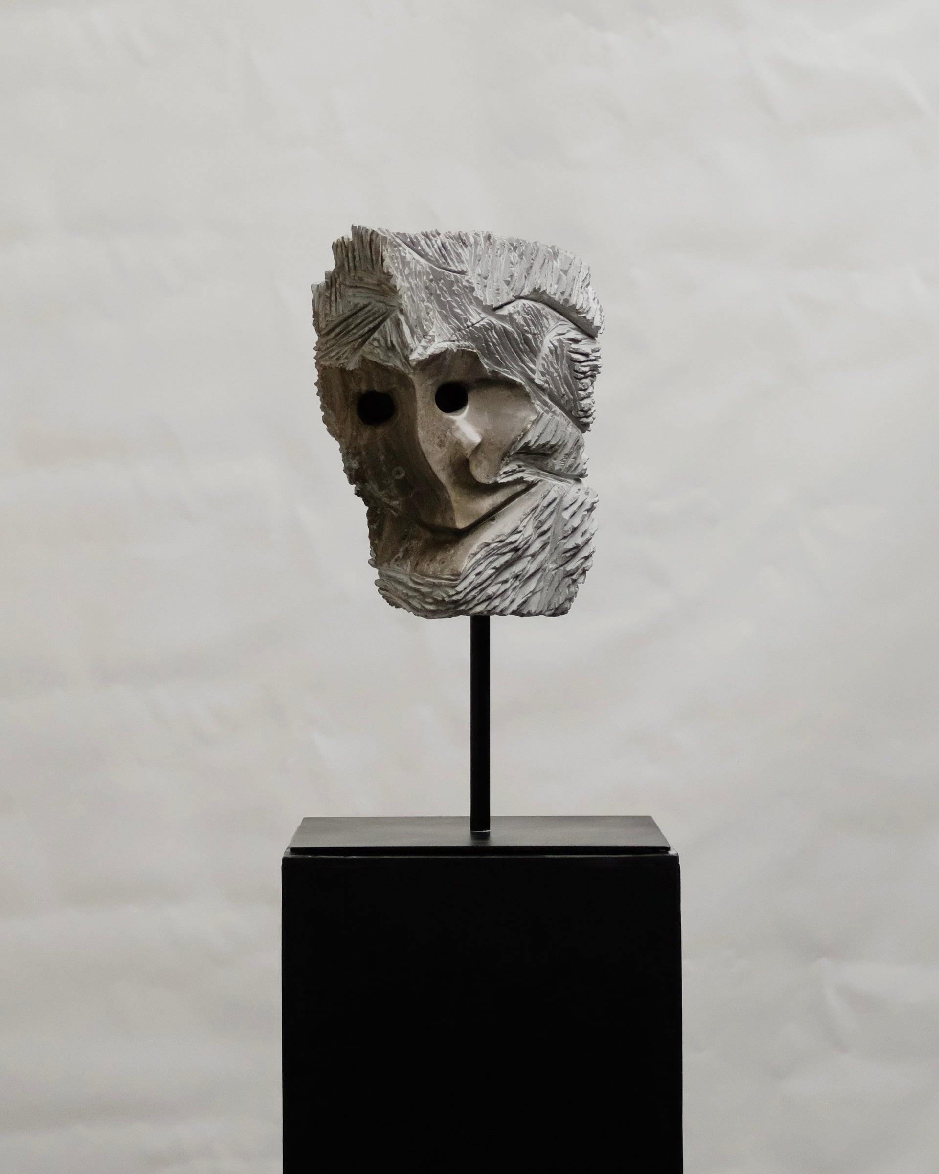 RIN limestone sculpture, full view on its black stand